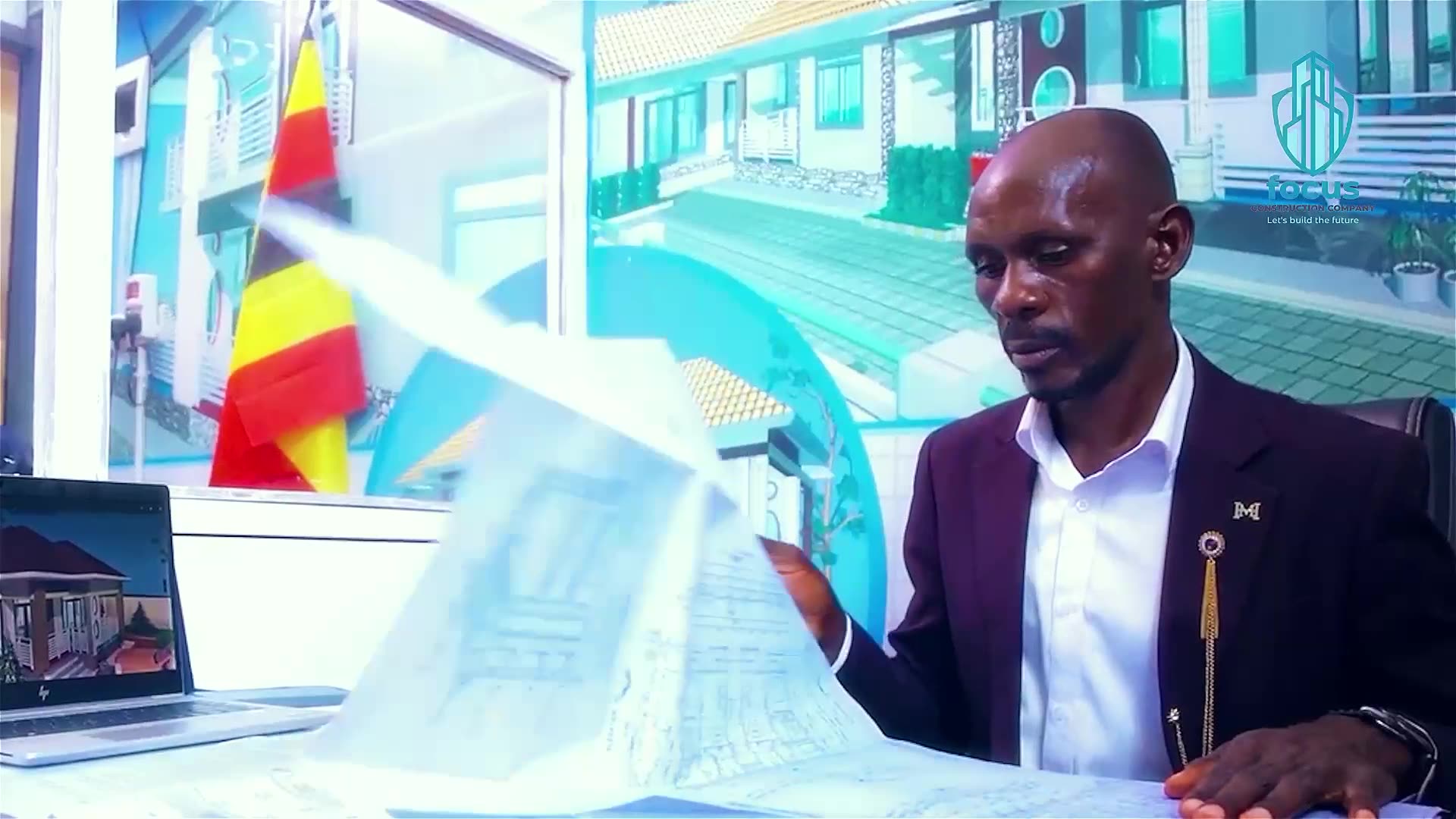 Eng. Ddungu Peter reviewing drawings in the Focus office